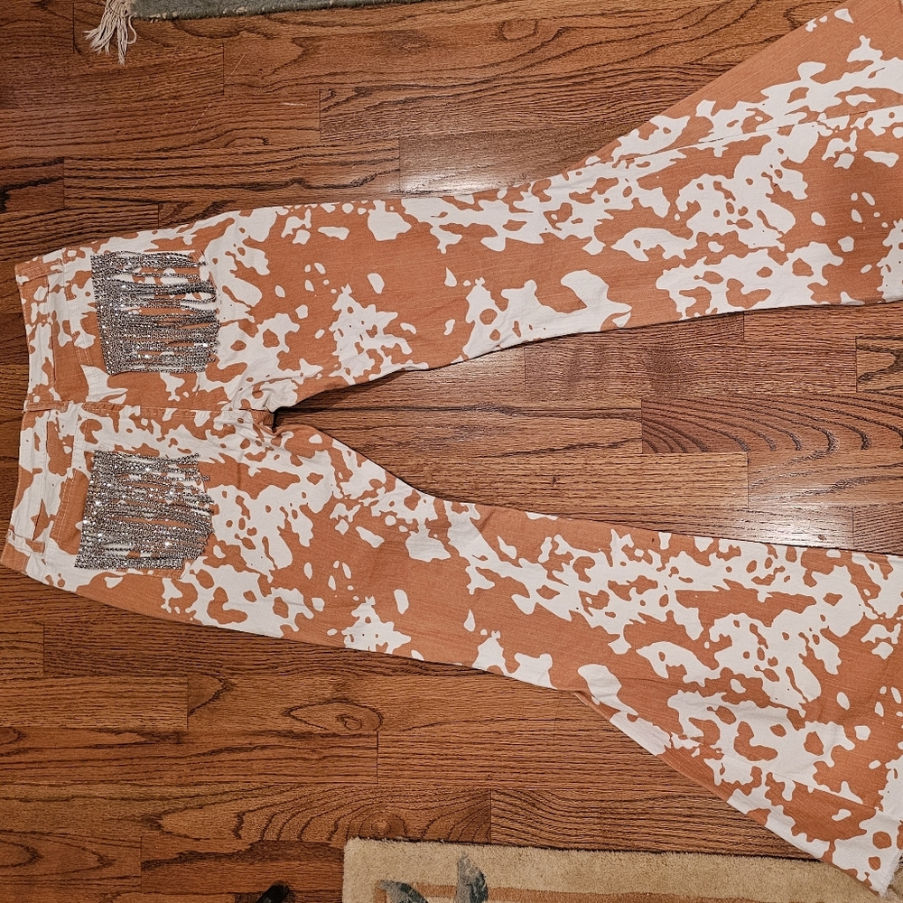 Saints and hearts cow print bell bottoms